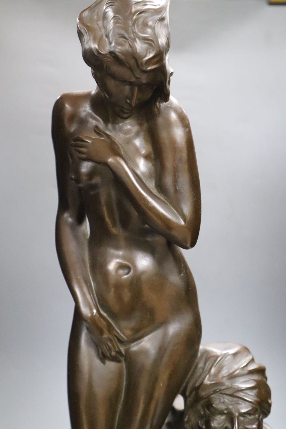 A large bronzed figure group of a seated male and nude female, indistinctly signed, 66cm